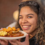 A student with her plate of food at Late Night Breakfast, fall 2025; photo by Natalie Hoang ’25, MBA ’26