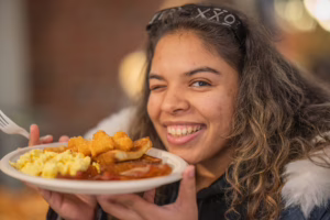 A student with her plate of food at Late Night Breakfast, fall 2025; photo by Natalie Hoang ’25, MBA ’26