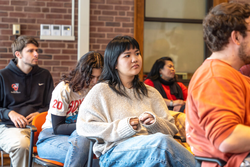 students in seats at event