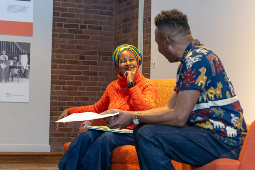 author and professor sitting in chairs talking