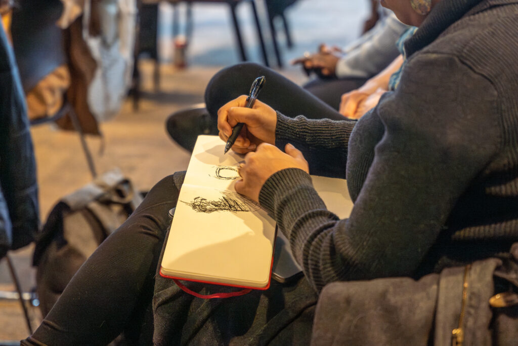 student sitting in chair sketches