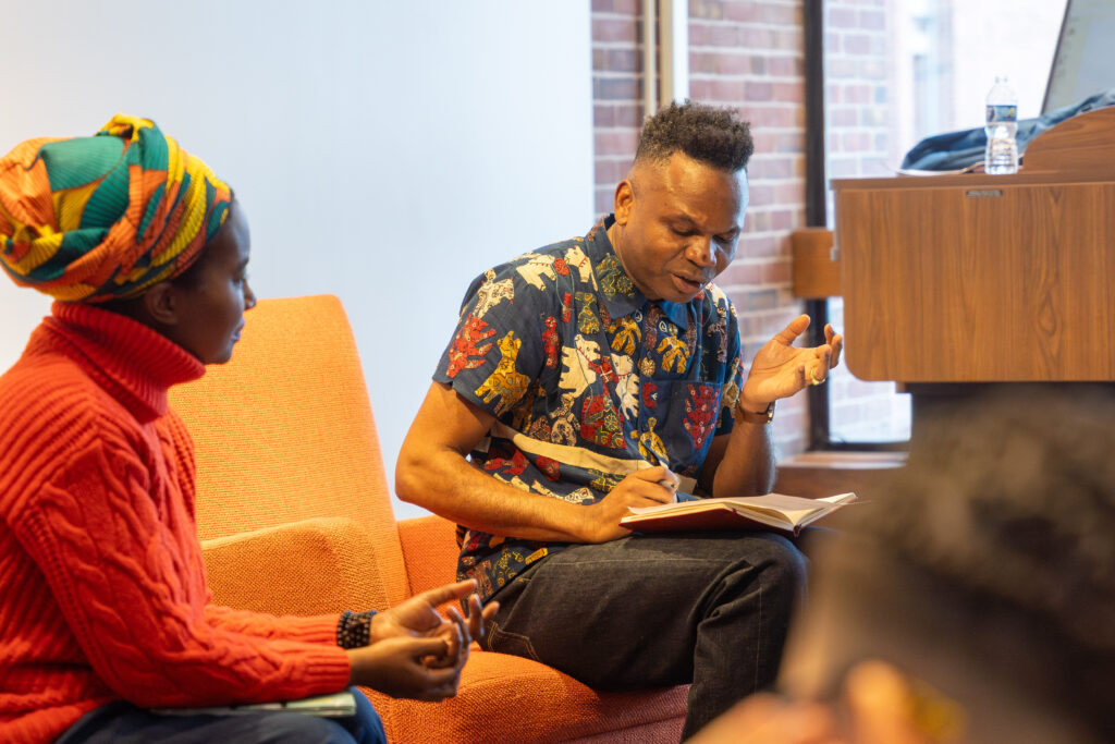 author and professor sit in chairs talking