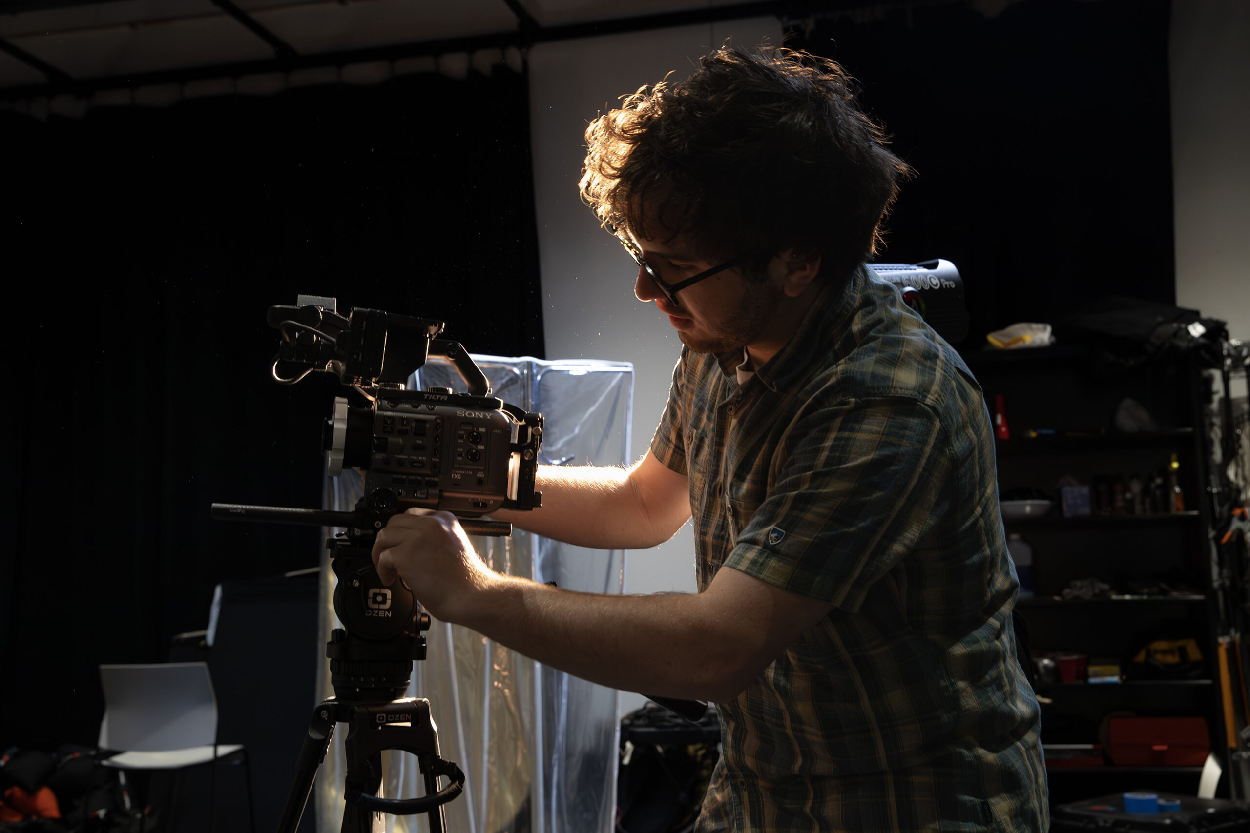 person with camera in studio