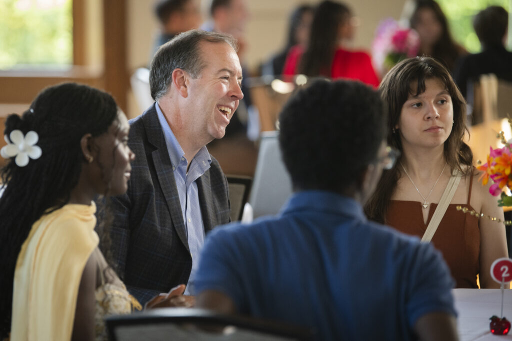 students and provost sit at table