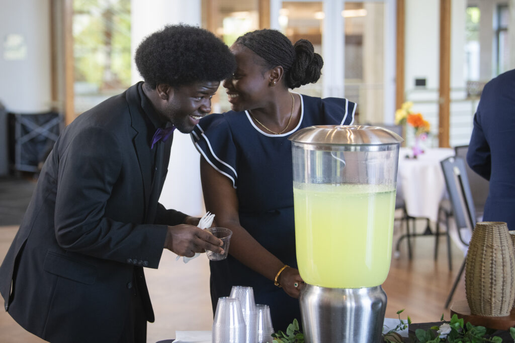 two students talk while getting lemonade
