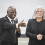 man with microphone stands next to woman