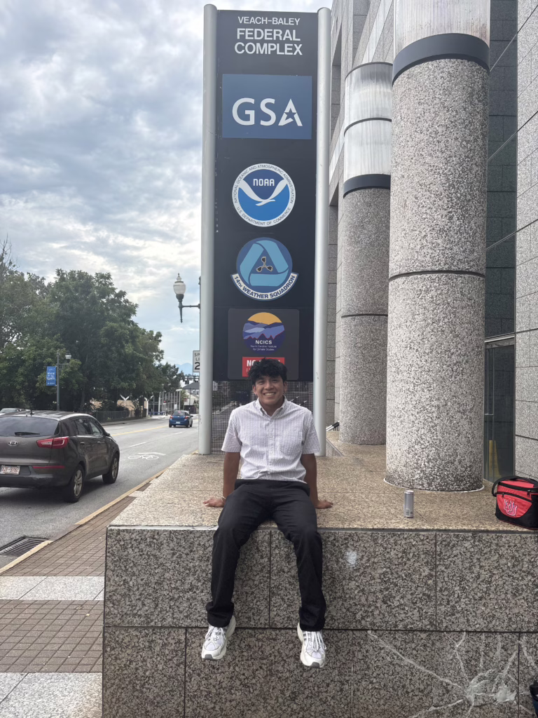 student sitting outside building