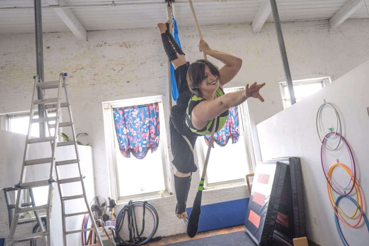 student practicing trapeze
