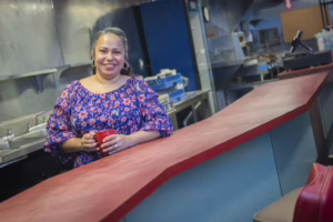 person holding mug at restaurant counter