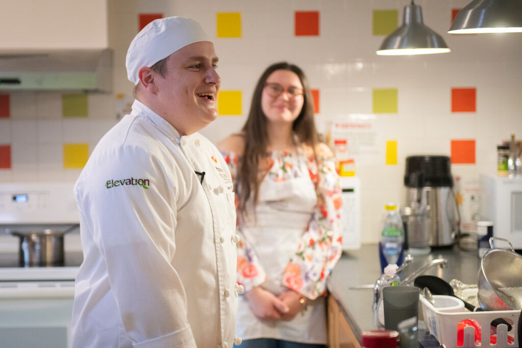 Branson Witt relaxes with peers while preparing food