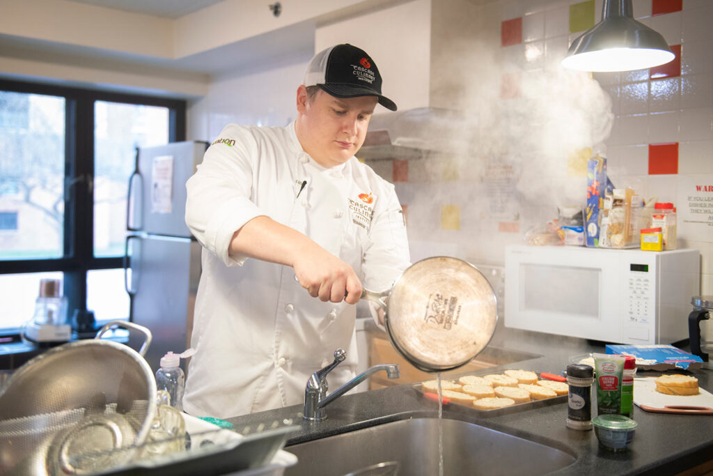 Branson Witt prepares food using culinary skills honed in a cooking class
