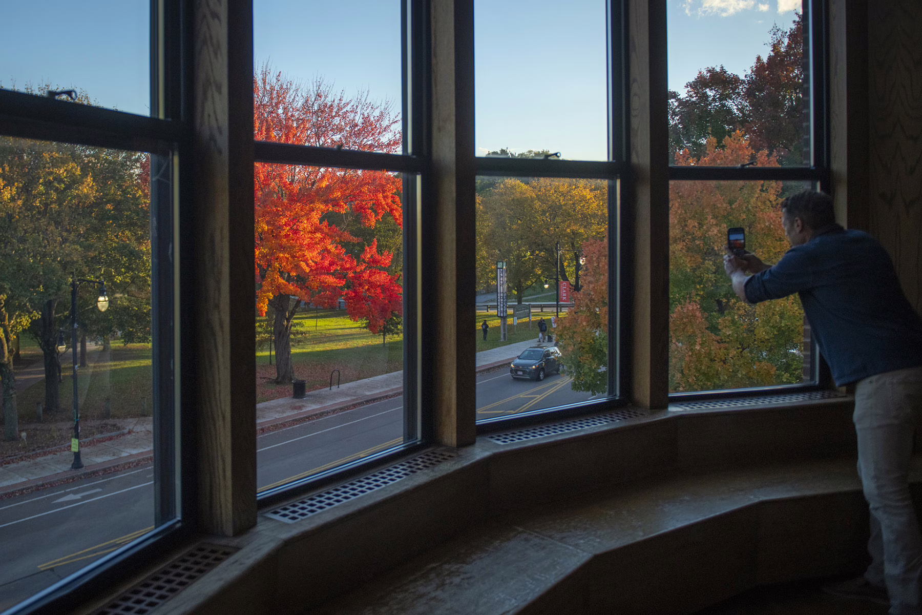 Person taking photo out of a window in the Higgins University Center