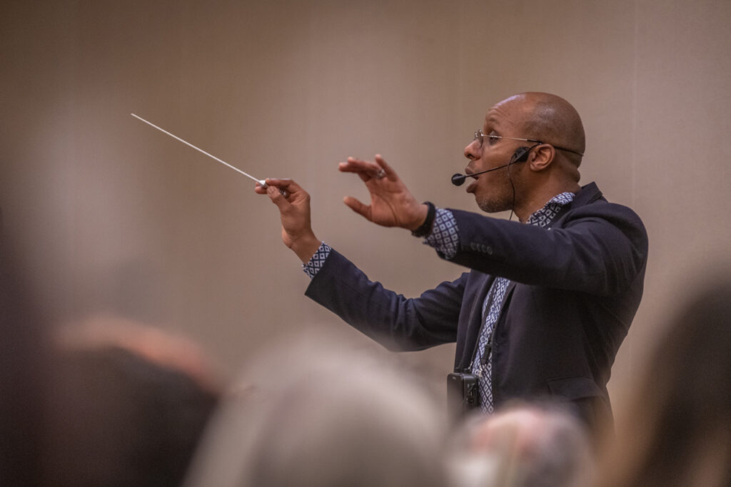 Cailin Marcel Manson leads a rehearsal of the combined choir for their Carnegie Hall concert