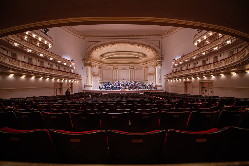 The combined choir rehearsing at Carnegie Hall