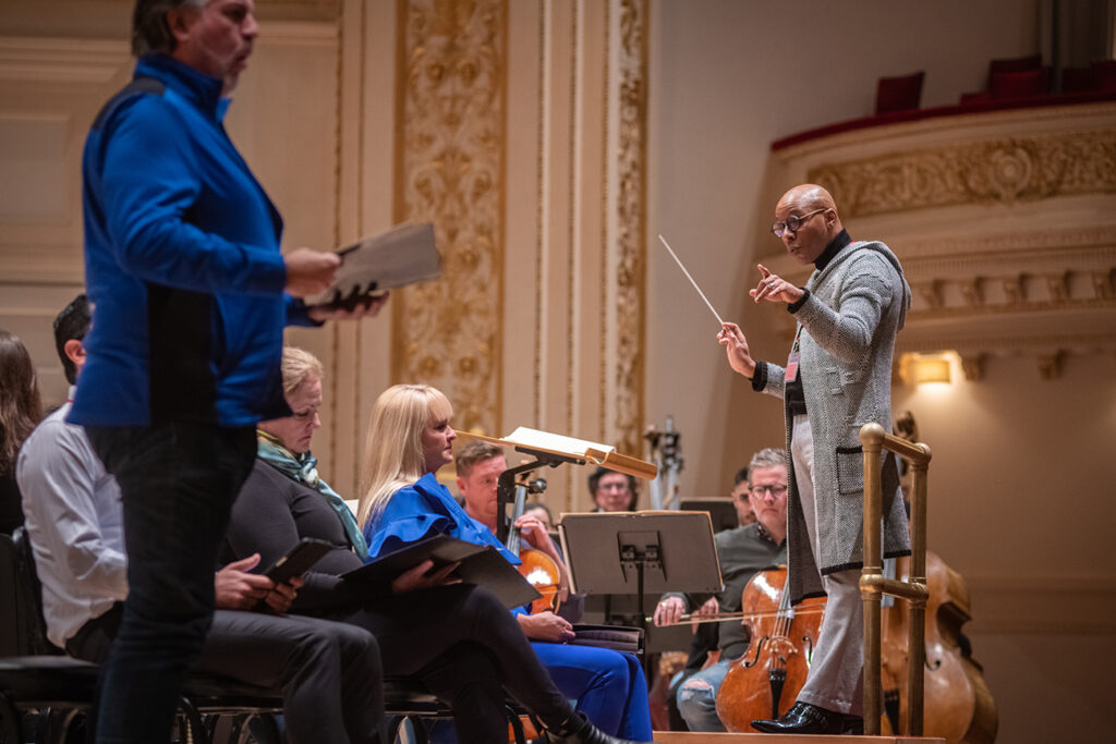 The combined choir rehearsing at Carnegie Hall