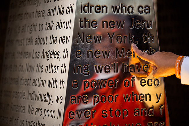 Carolyn Michael-Banks' reflection in the "I Am a Man" sculpture