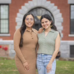 two people pose for photo on campus