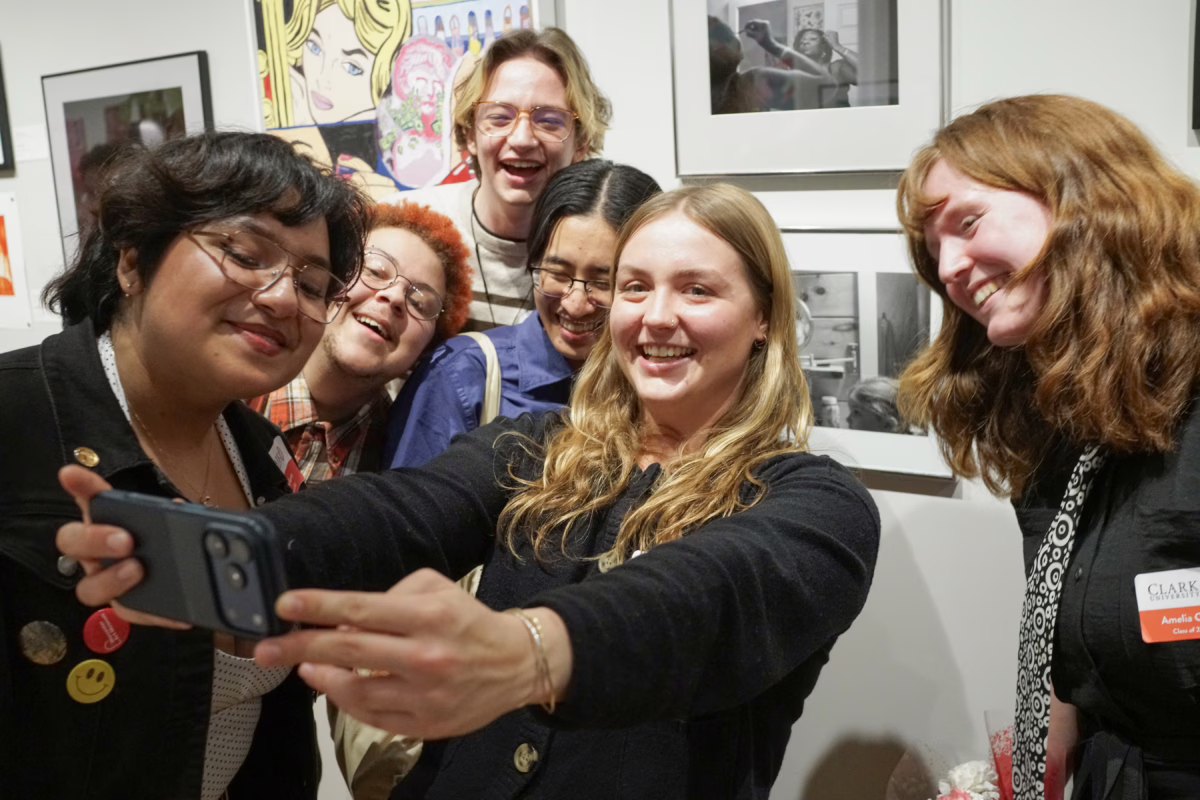 students posing for selfie in gallery