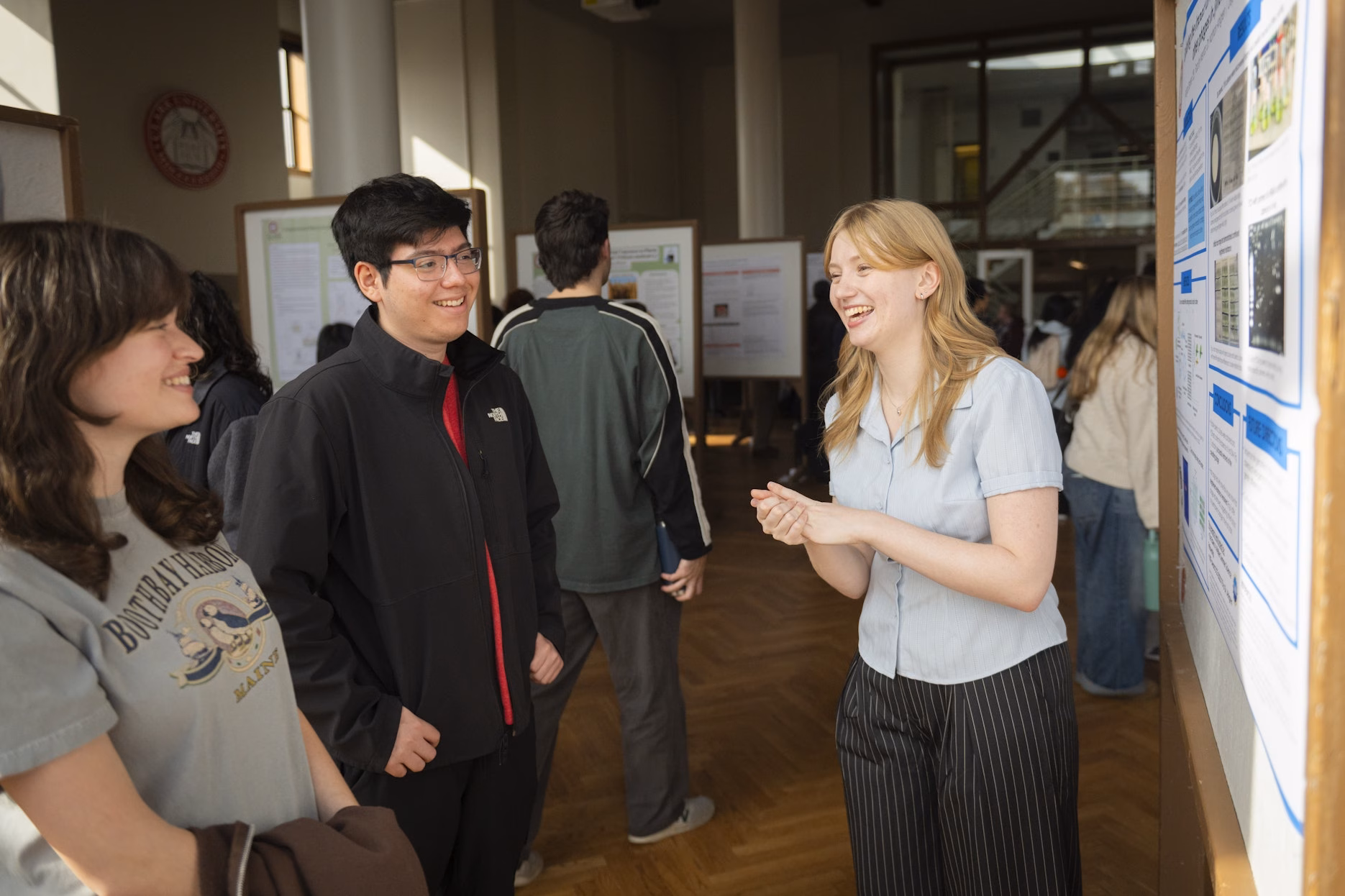 students display research posters at college campus
