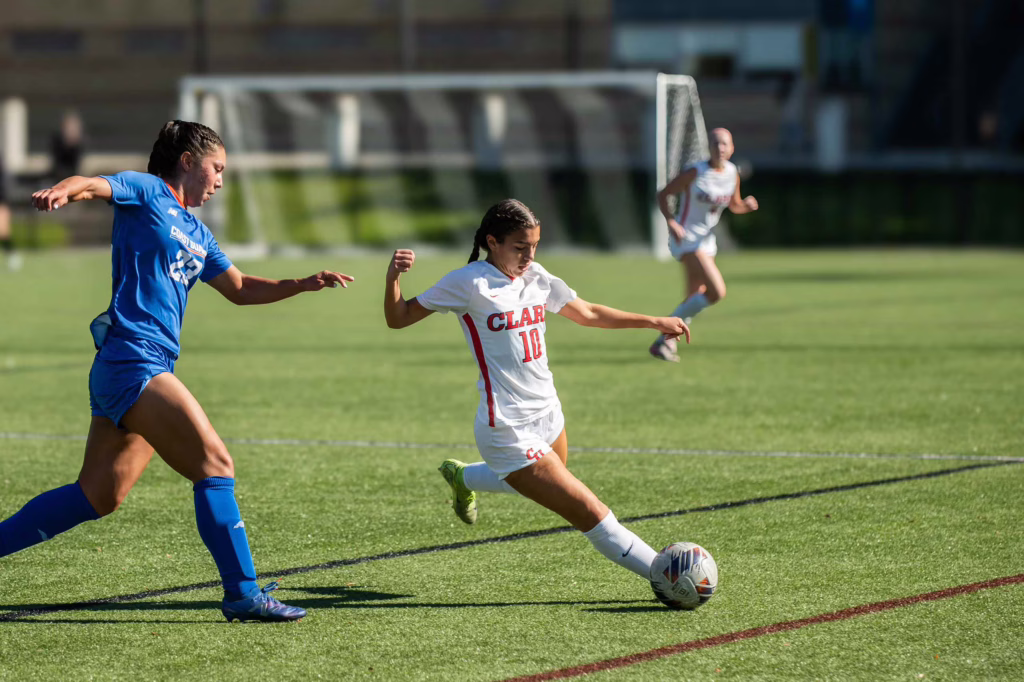 A Clark student athlete competes in a soccer game during Friends and Family Weekend