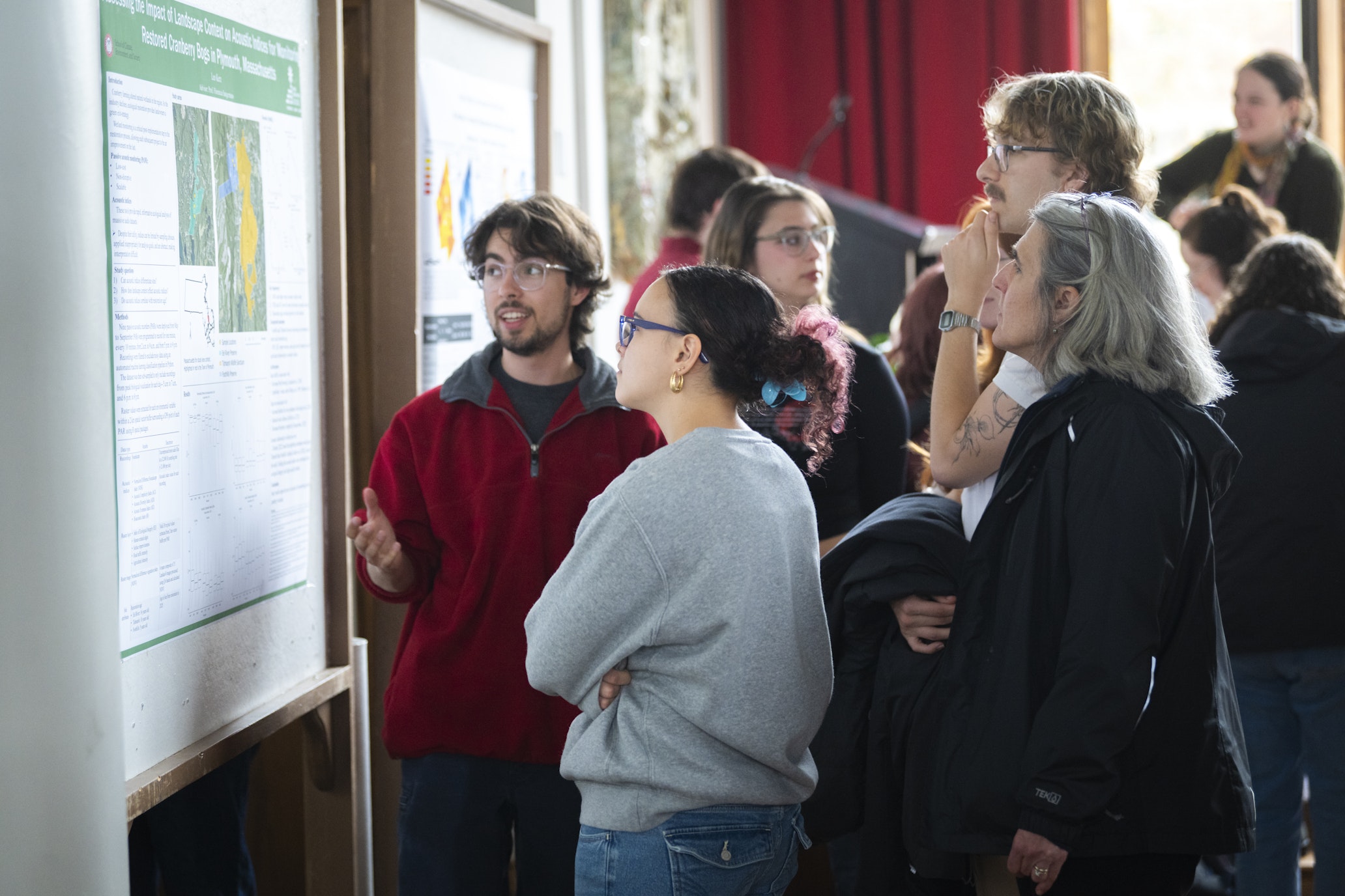 student presents research poster