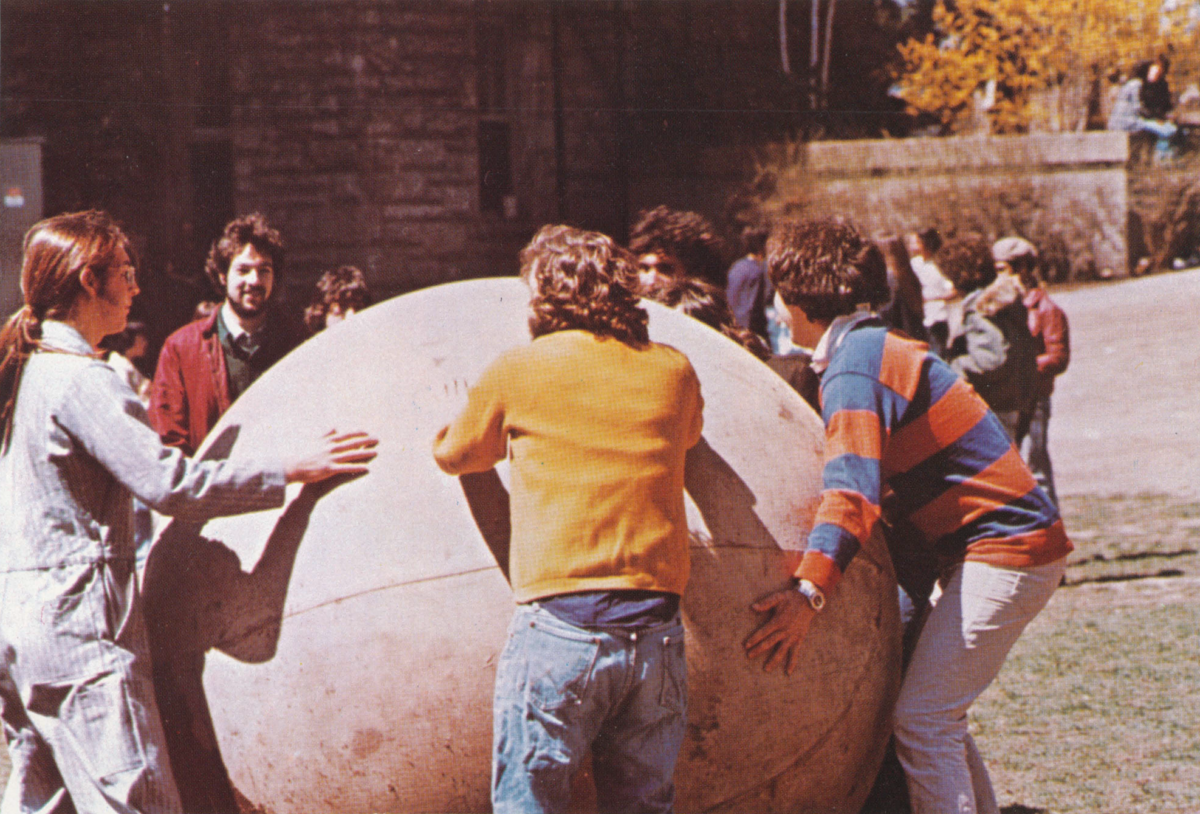 Students rolling giant ball on the Clark Univeristy campus