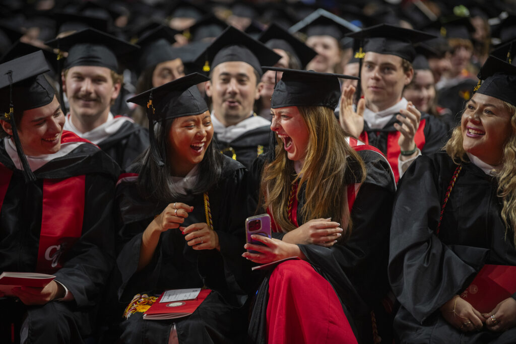 Graduates laugh during Commencement 2025