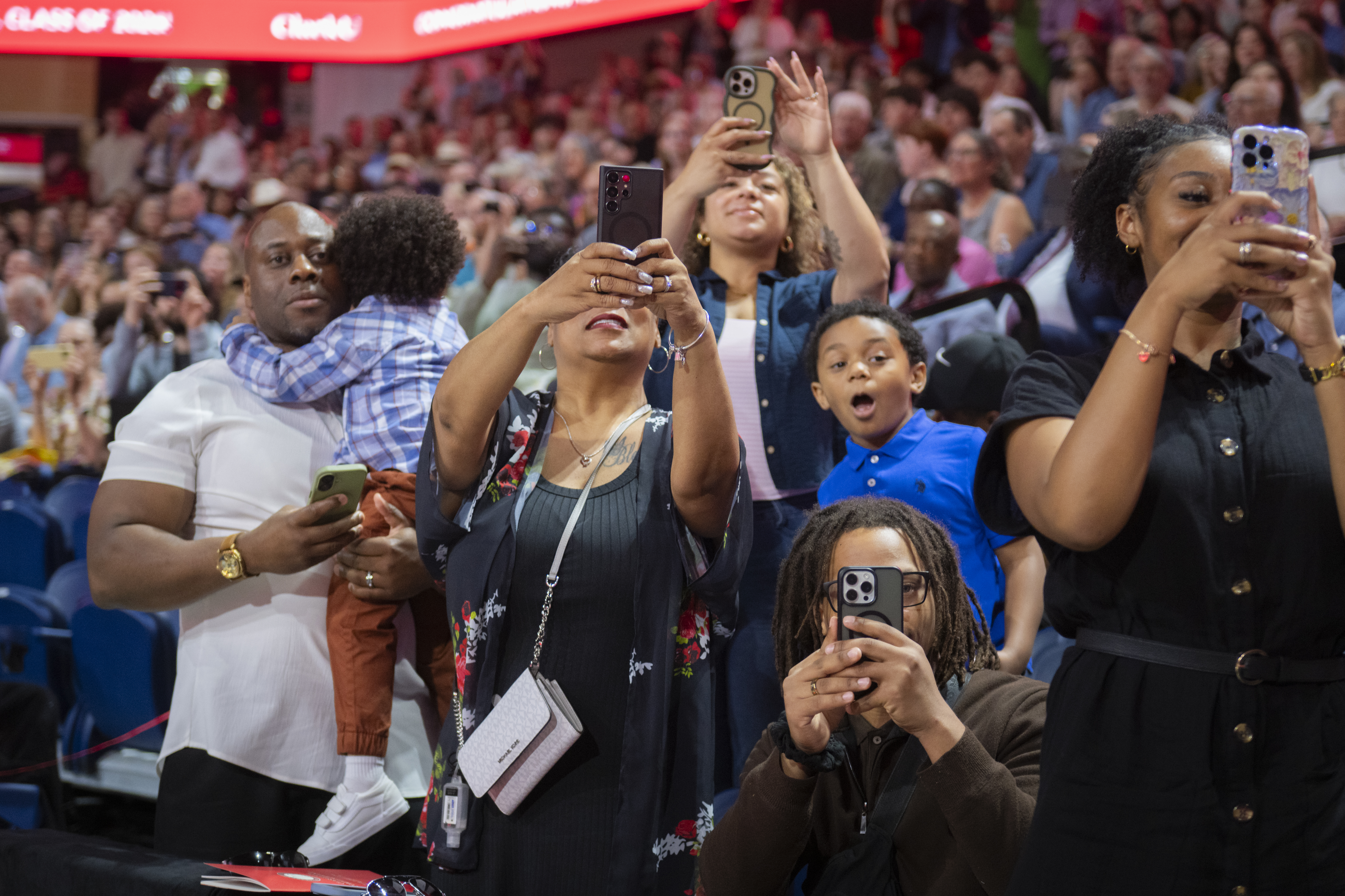 Family takes photos of students at Clark University Commencement