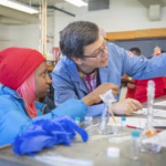 Professor Julio D'Arcy shows students how to do chemistry