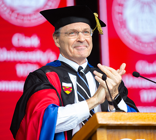 Davis Baird applauds at the graduate commencement ceremony