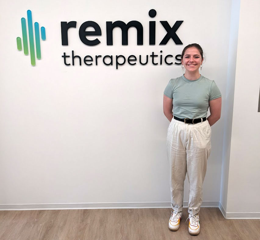 Devon Rose Leaver stands in front of the Remix Therapeutics sign