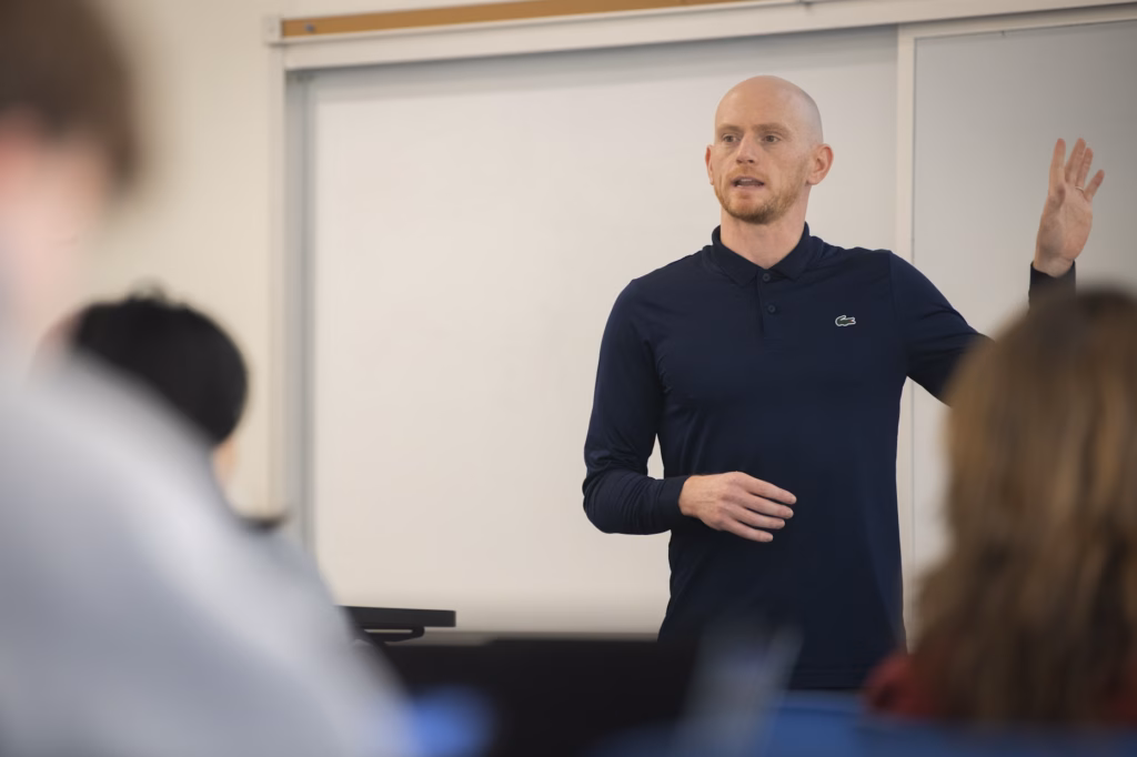 professor at front of classroom lecturing to students