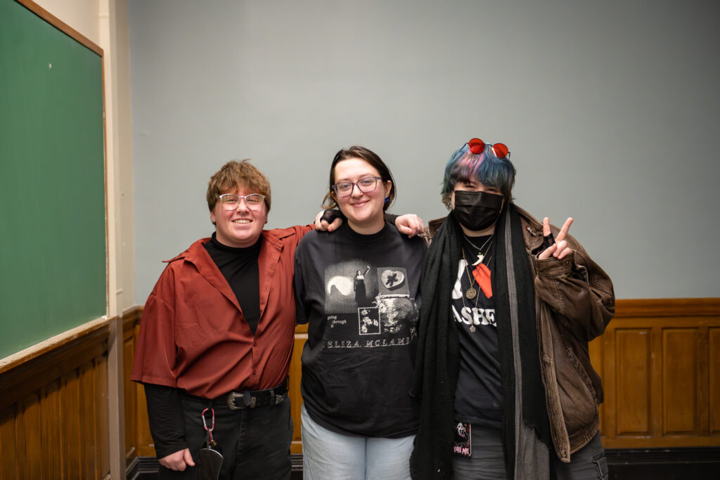three students pose for photo
