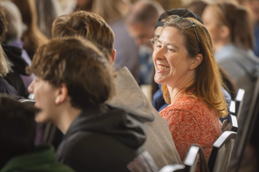 woman smiles at person sitting next to her