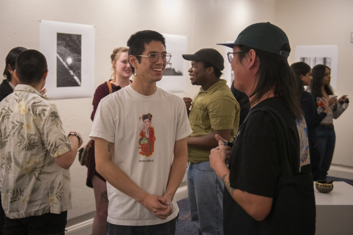 group of people talking in gallery space