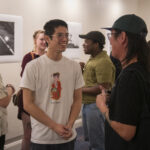 group of people talking in gallery space