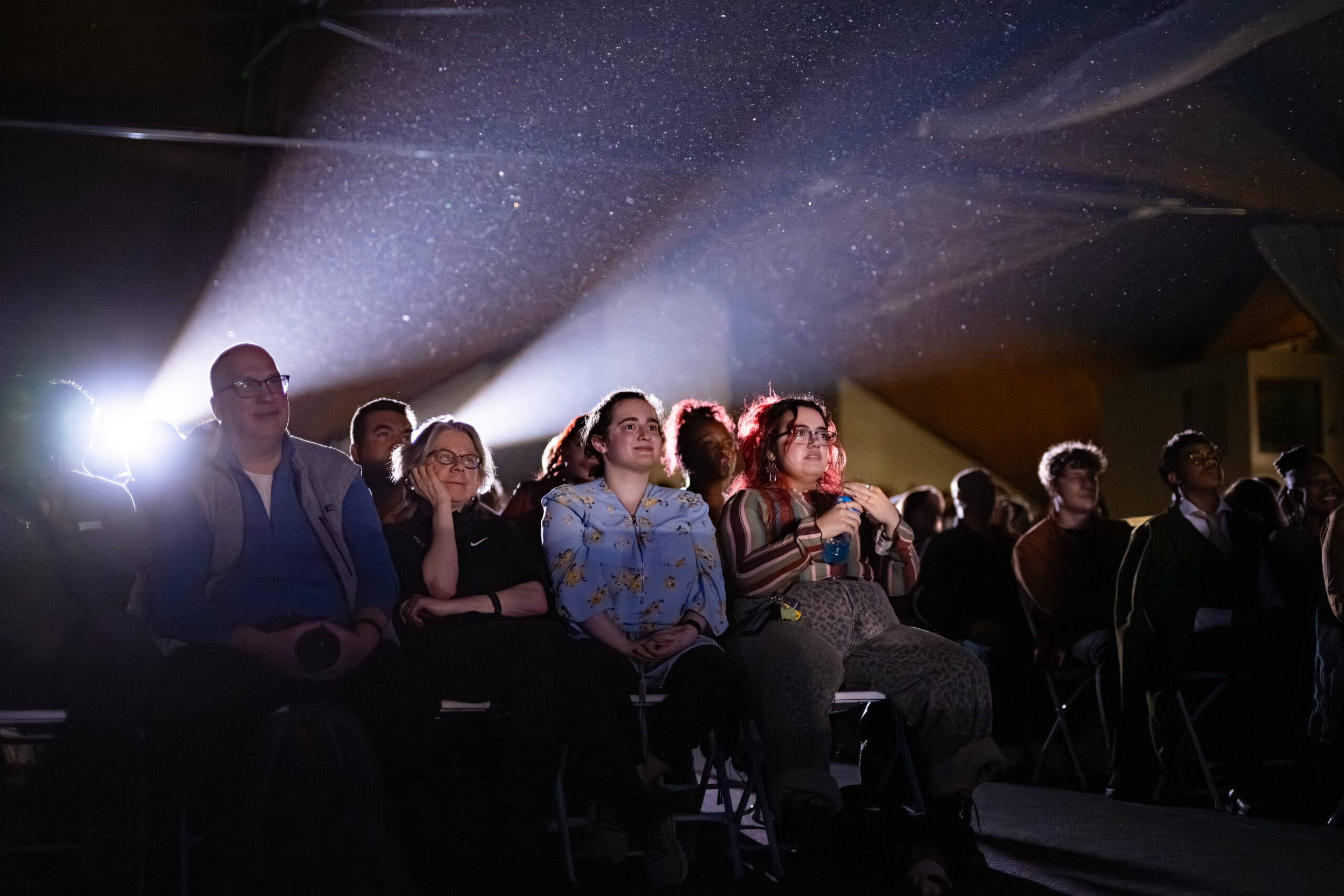 people in crowd watch stage