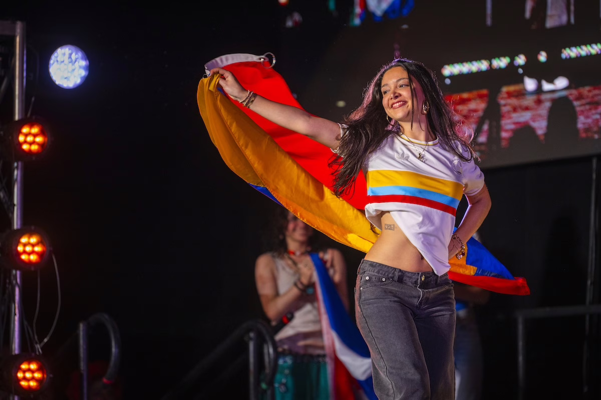 people on stage with flags