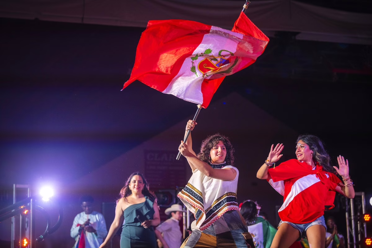 people on stage with flags