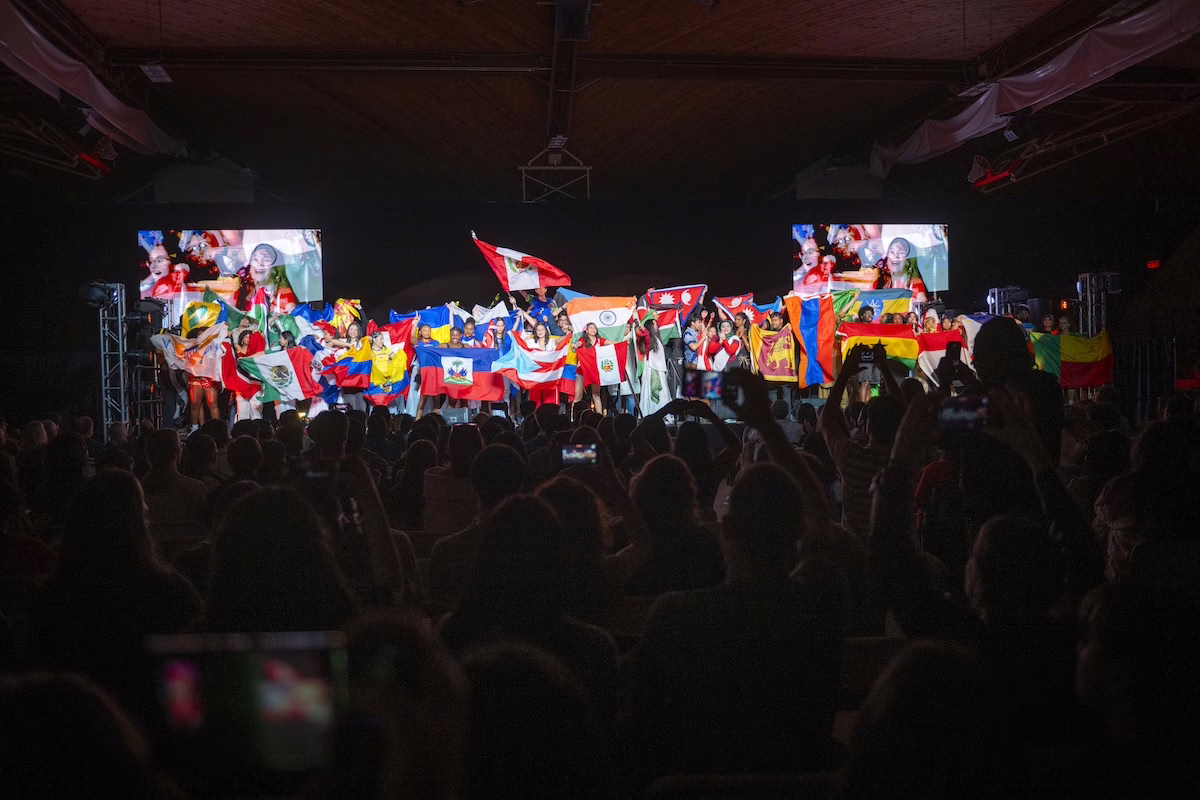 people on stage with flags