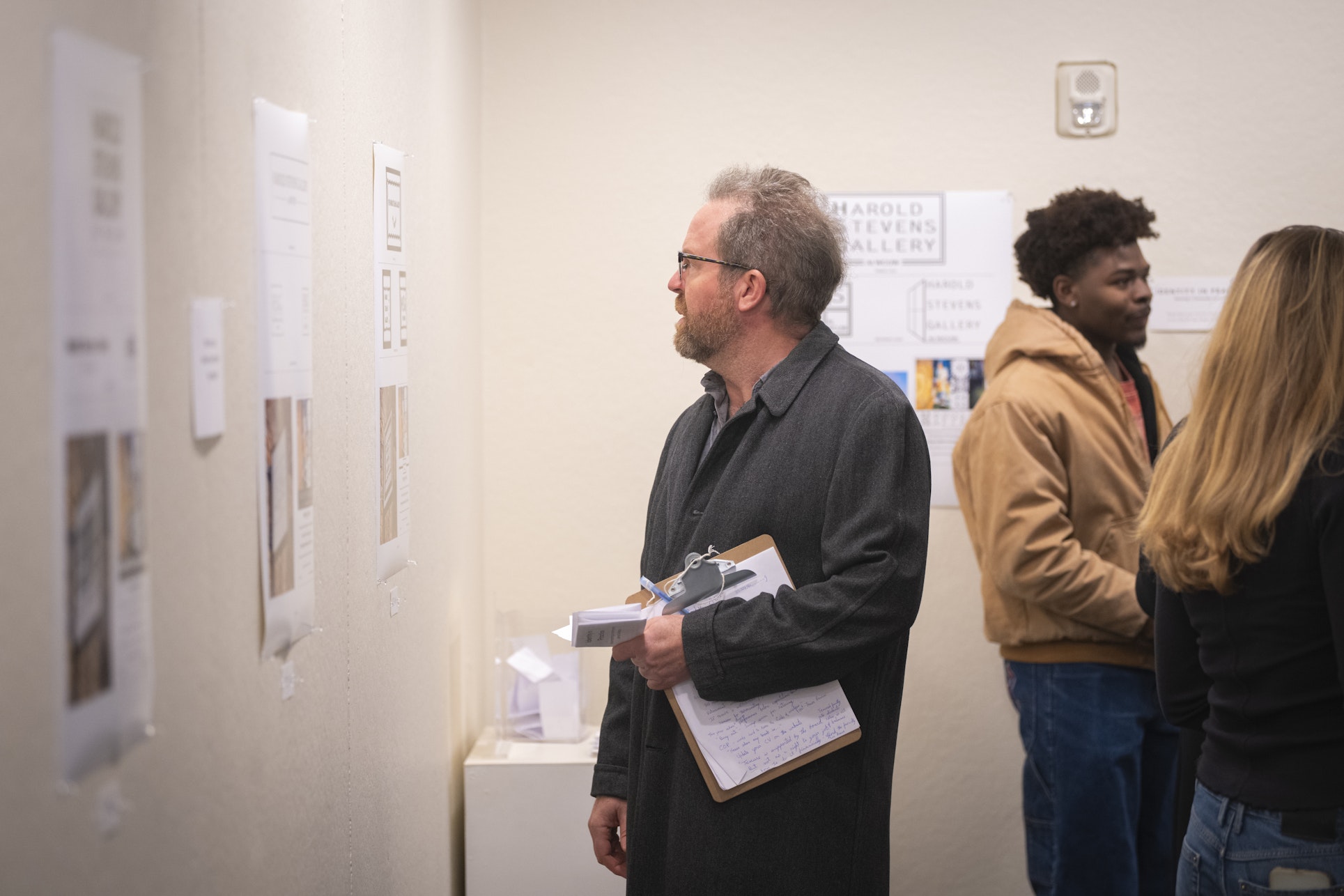 person looks at graphic in gallery show