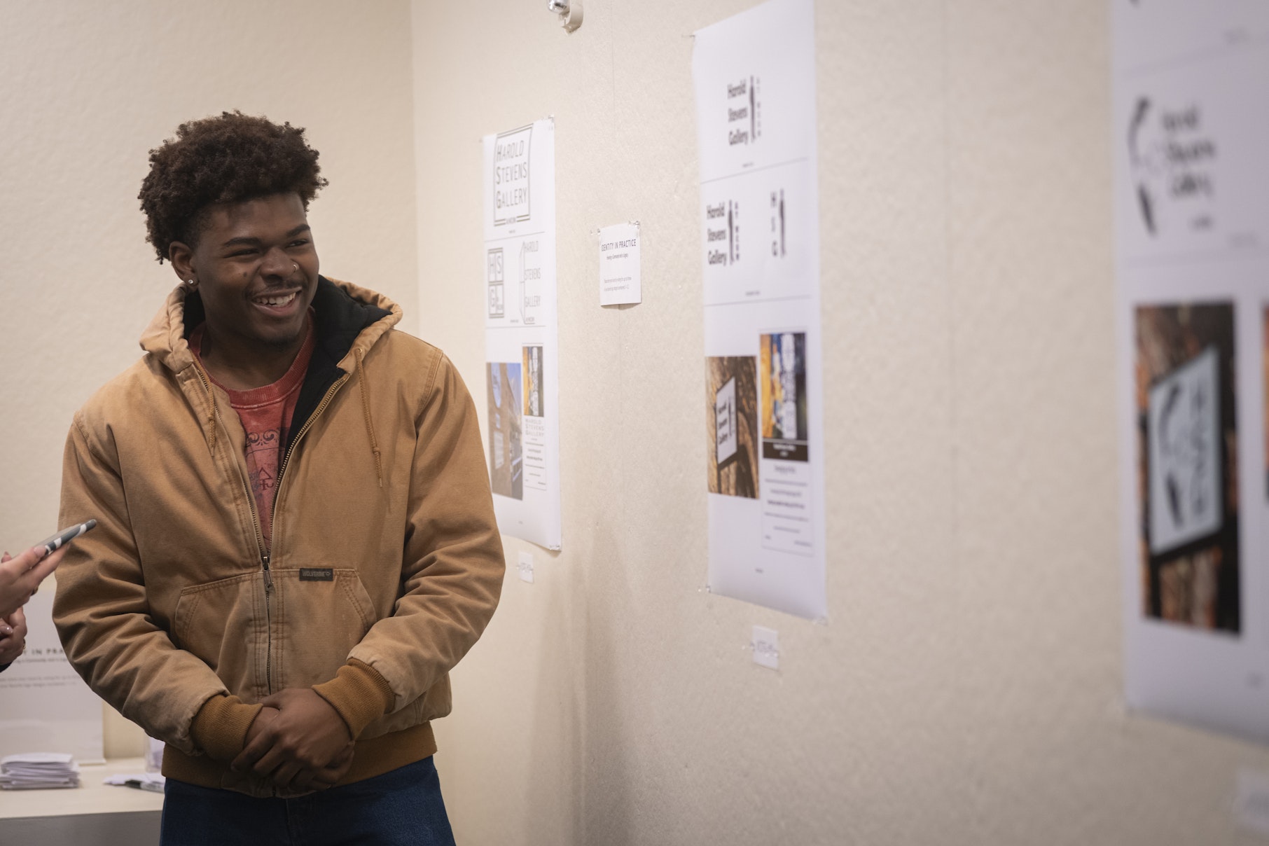 student shows off work at gallery