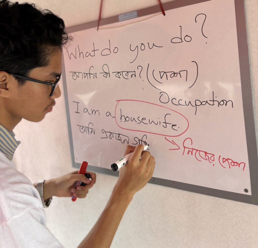 college student writes on whiteboard