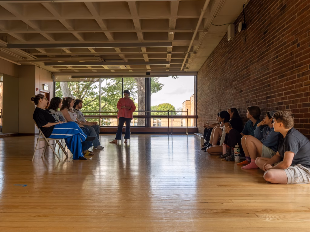 actor talks to students sitting in rows