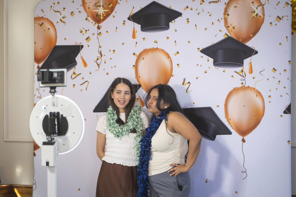 students smile at graduation ceremony
