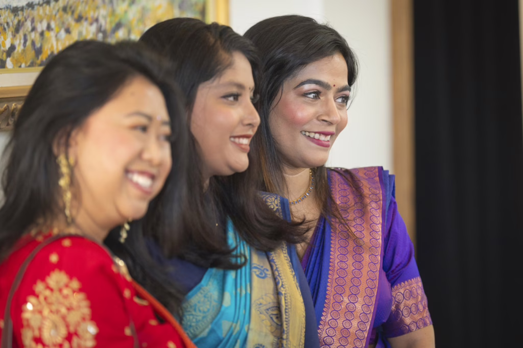 students smile at graduation ceremony