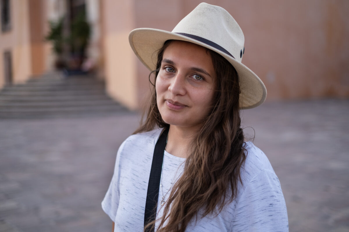 headshot of woman in hat