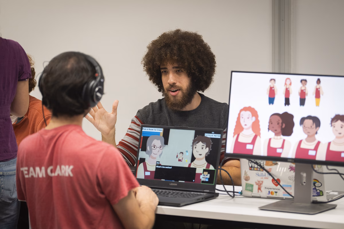 Students working together at the computer to create games