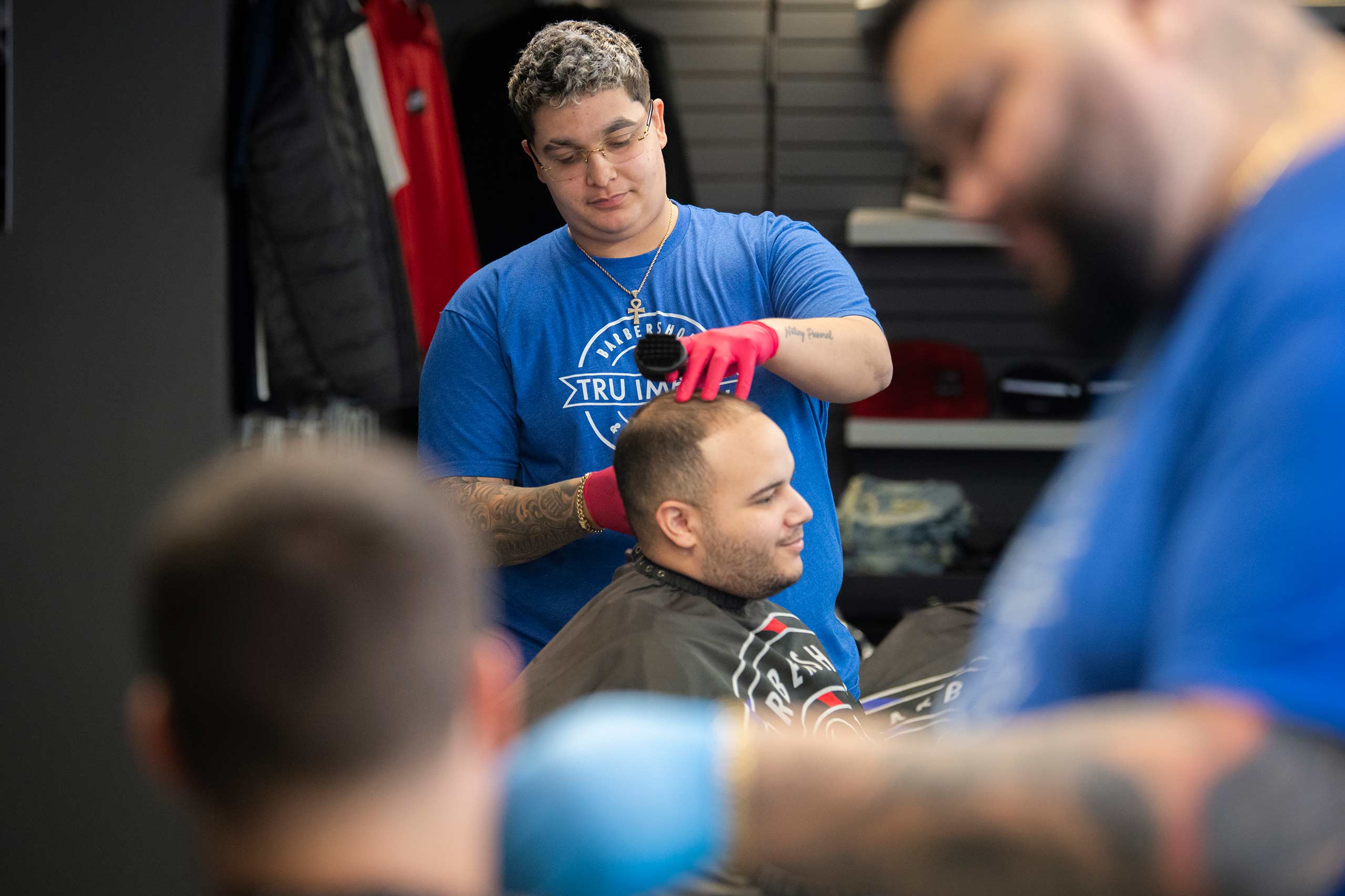 Business owner and LARC alum Jordan Santiago at work in his Worcester barbershop