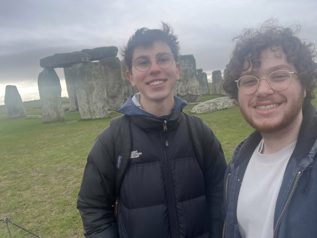 two people in front of stonehenge